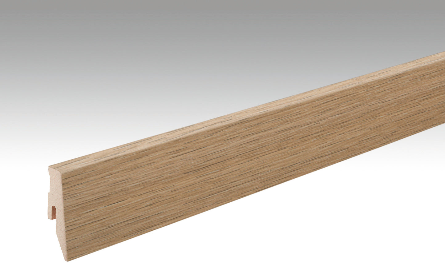 Eine lange, schmale Fußleiste mit natürlicher Holzoptik, sichtbare Maserung in Eichenfarbe, Querschnitt kantig, Oberfläche glatt.